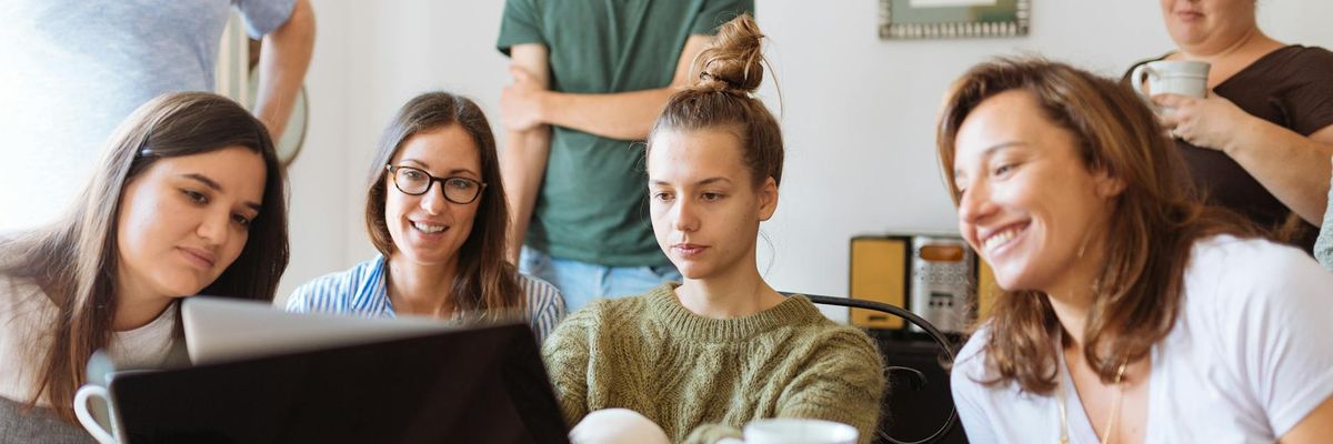 Group of diverse people working at laptops comfortably